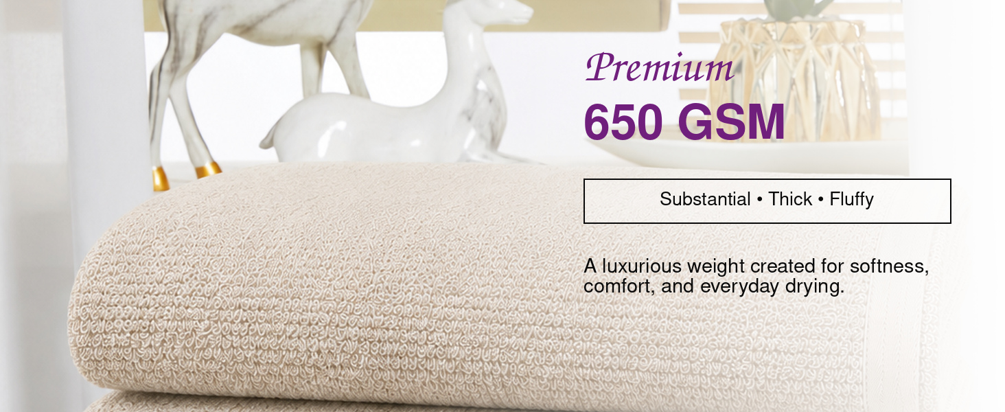 Two Squisita Champagne bath towels folded together showing the 27 by 54 inch size